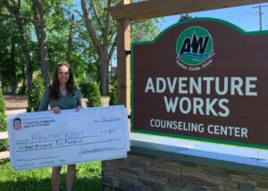 Adventure Works executive director with check from NNGO students